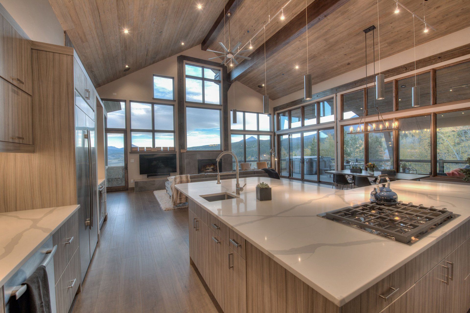 A kitchen with a large island and a stove top oven.