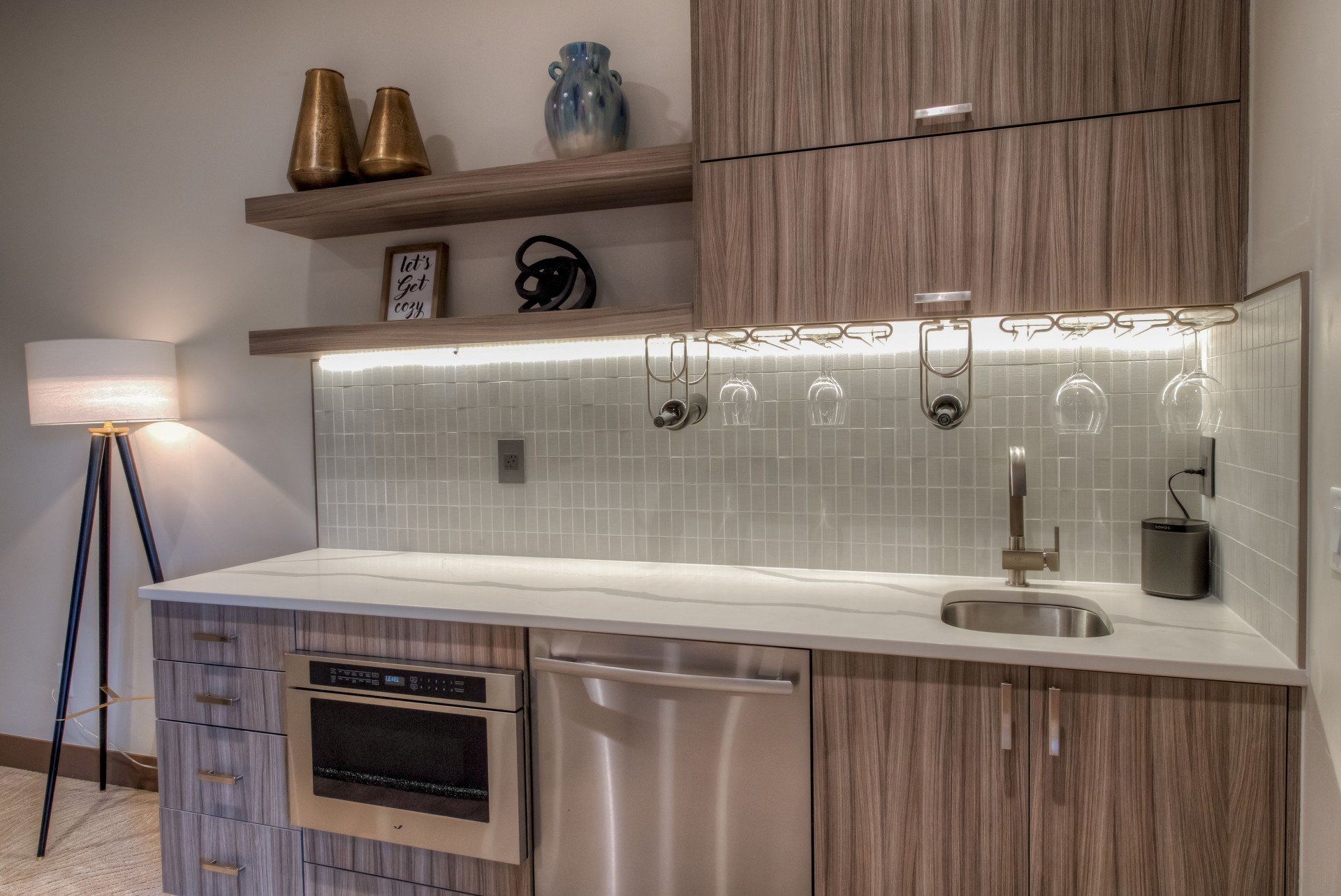 A kitchen with stainless steel appliances and wooden cabinets.