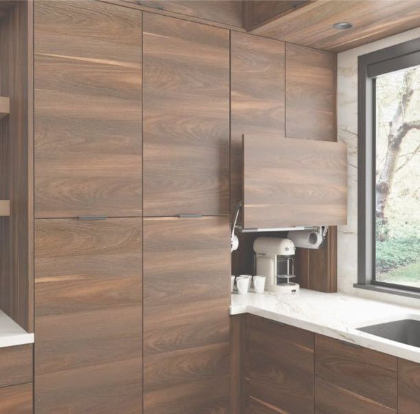 A kitchen with wooden cabinets and a window