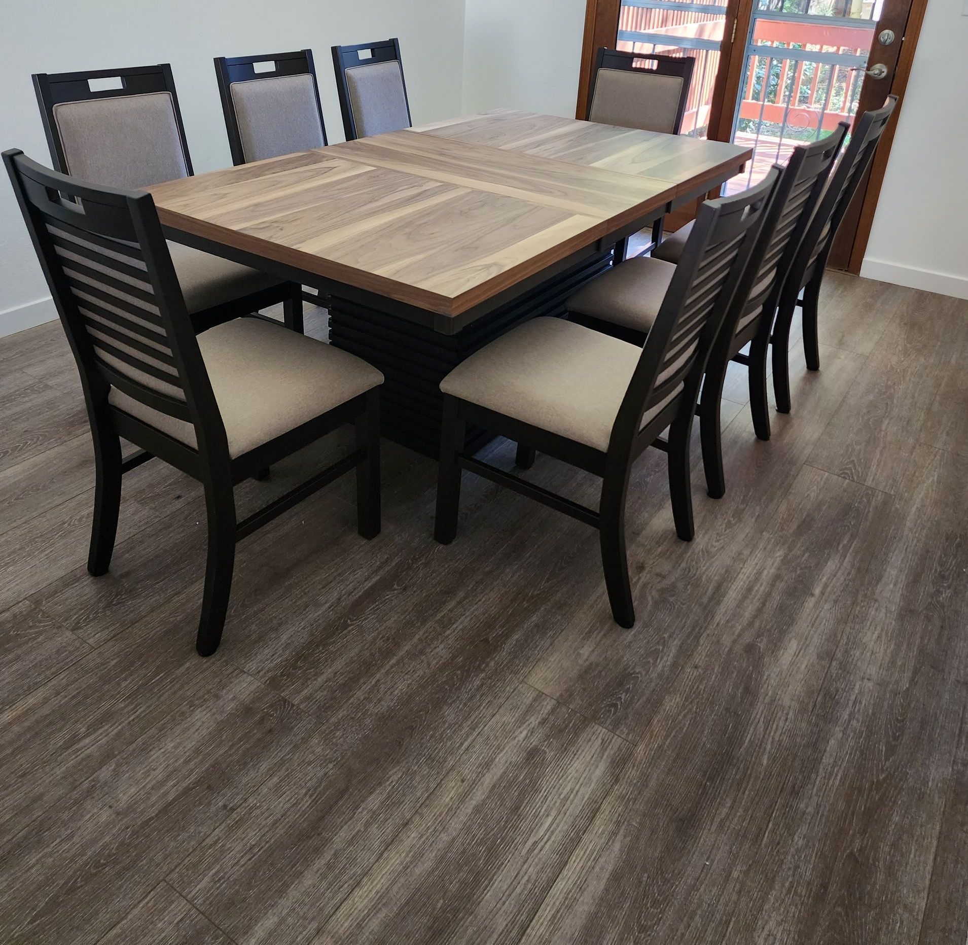 A wooden table and chairs in a dining room