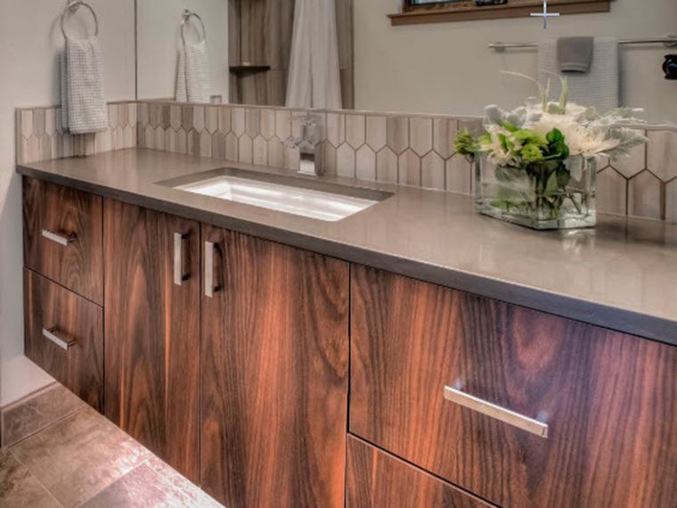 A bathroom vanity with wooden cabinets and a sink