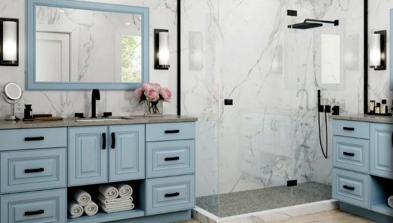 A bathroom with blue cabinets and a walk in shower.