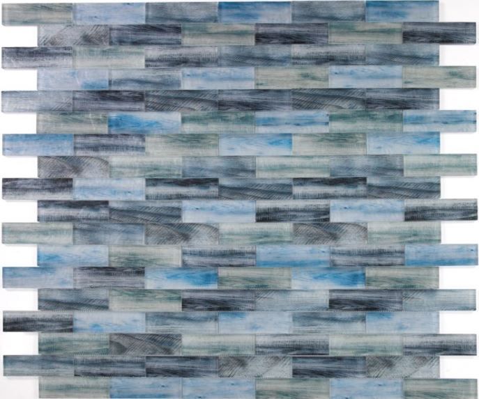 A close up of a blue and gray mosaic tile on a white background.