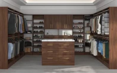 A walk in closet filled with lots of clothes and shoes.