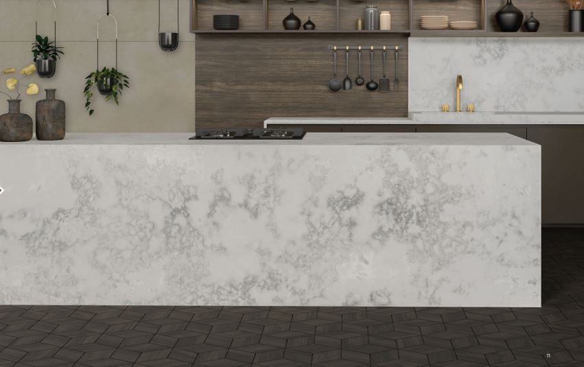 A kitchen with a large white counter top and a stove top oven.