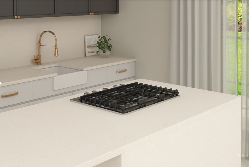 A kitchen with a stove top oven and a sink.