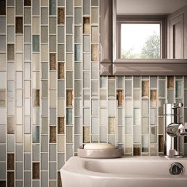 A bathroom with a sink and a mirror with tiles on the wall