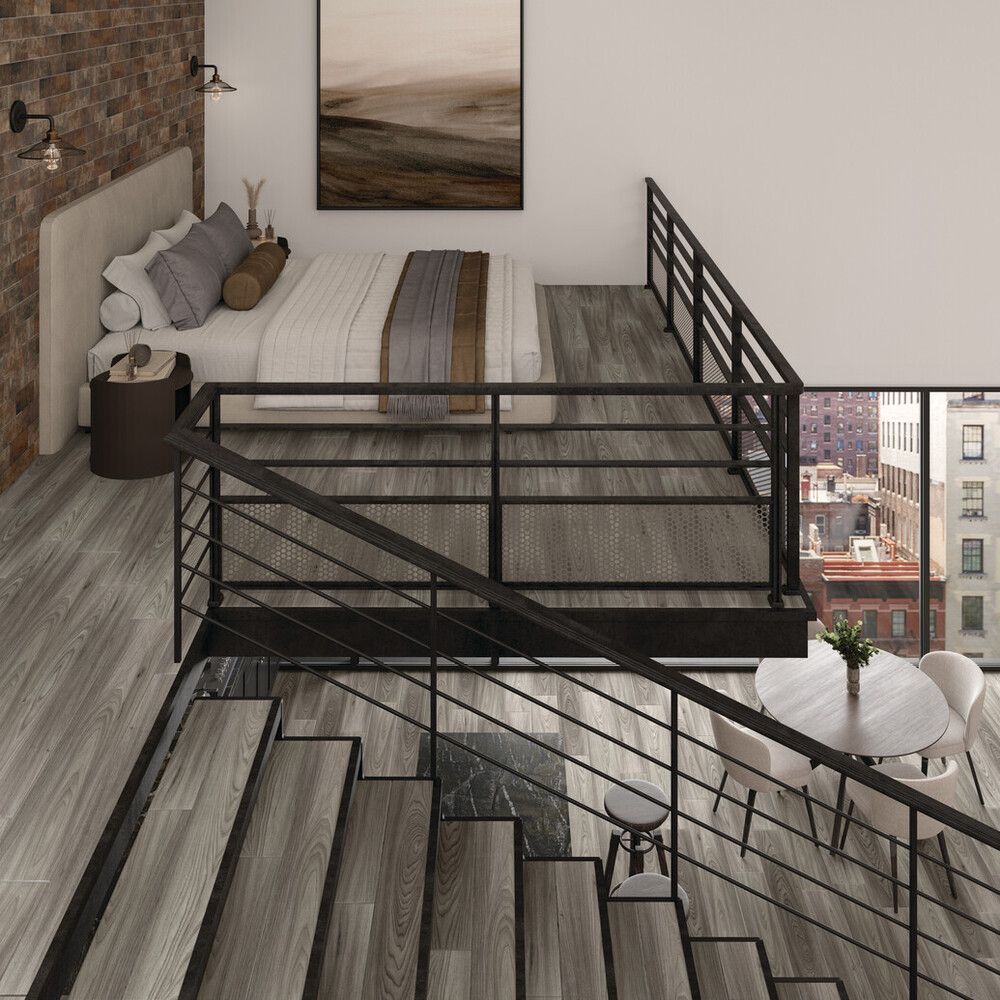 A bedroom with a bed and stairs leading up to it