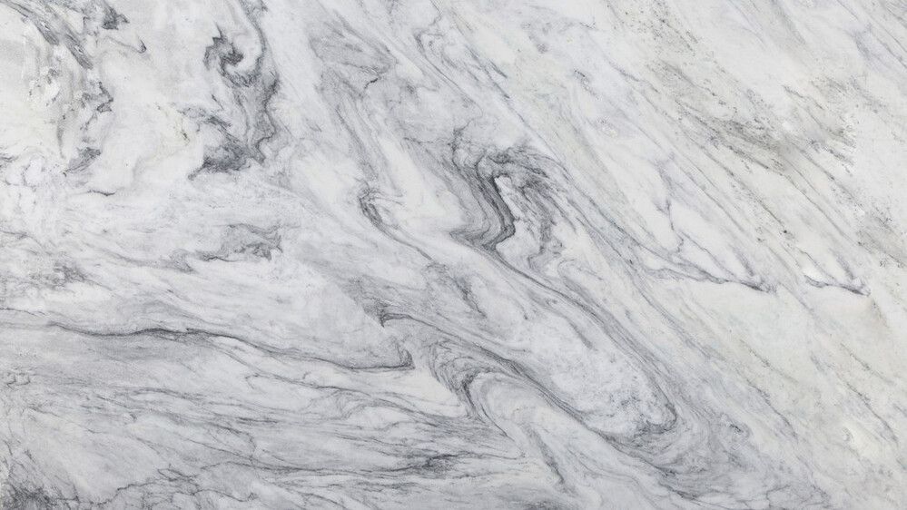A close up of a white marble counter top.
