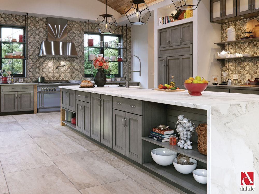 A kitchen with gray cabinets and a white counter top.