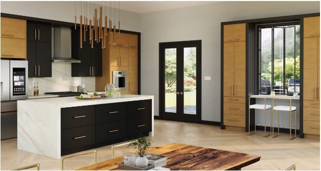 A kitchen with black cabinets and a large island in the middle of the room.