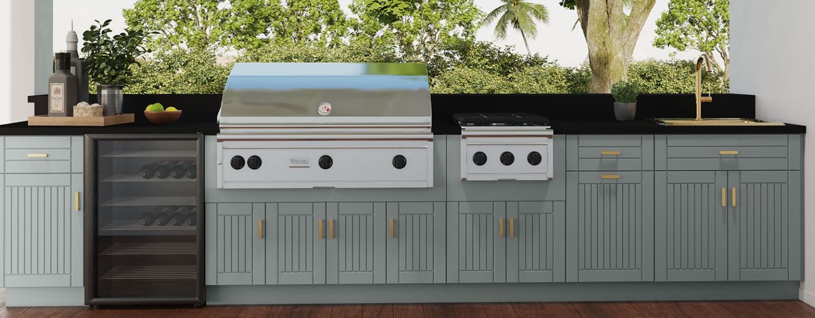 A kitchen with a grill , sink , and refrigerator.