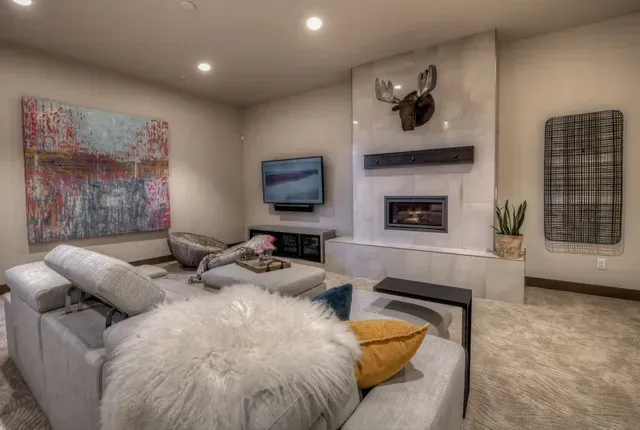 A living room with a couch , fireplace and television.
