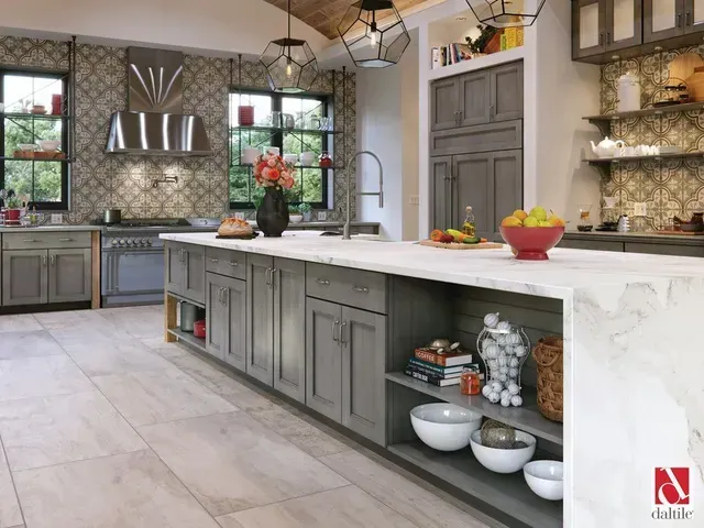 A kitchen with gray cabinets and a white counter top.
