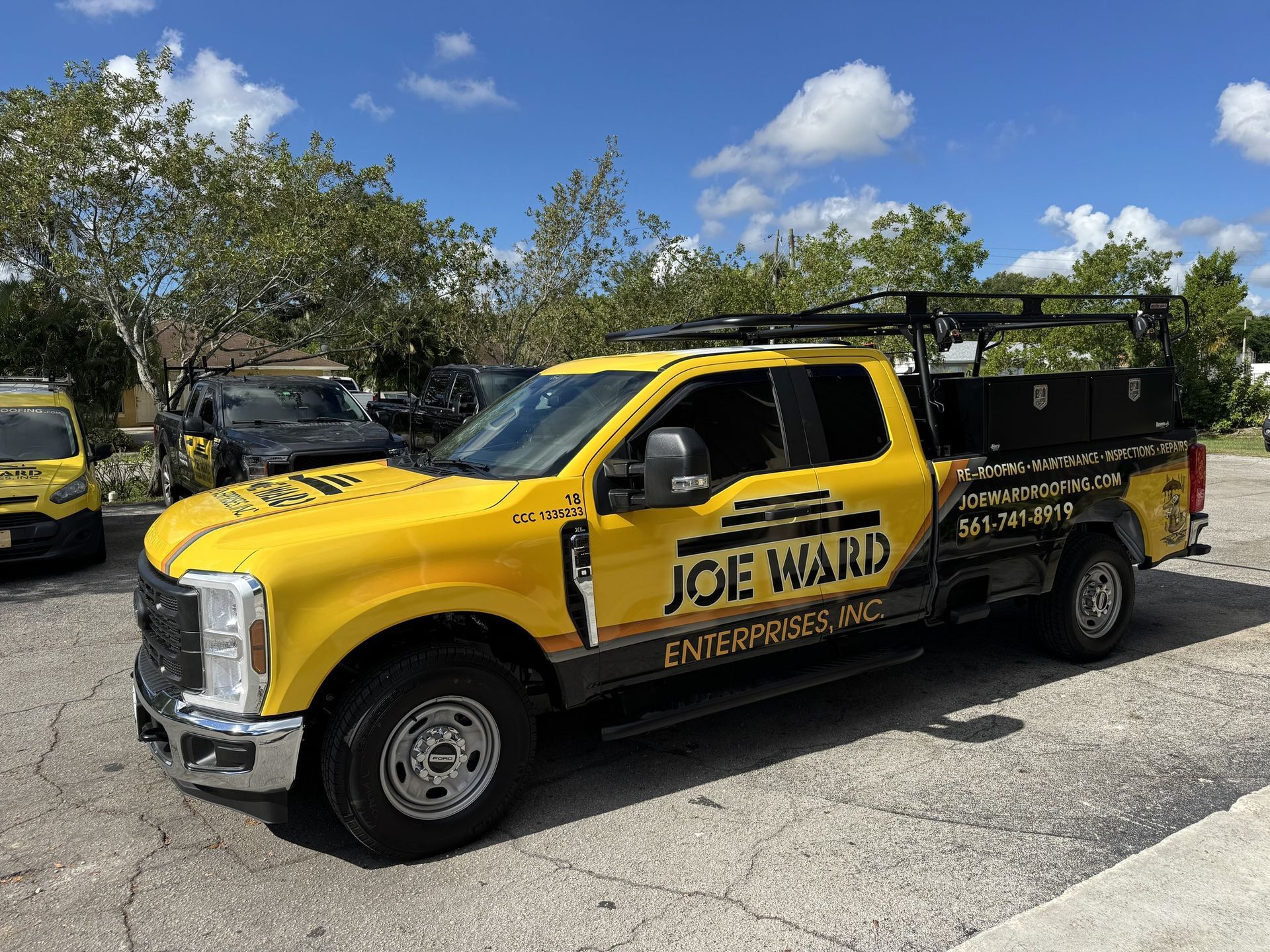 Yellow Joe Ward Enterprises truck parked outside on a sunny day.