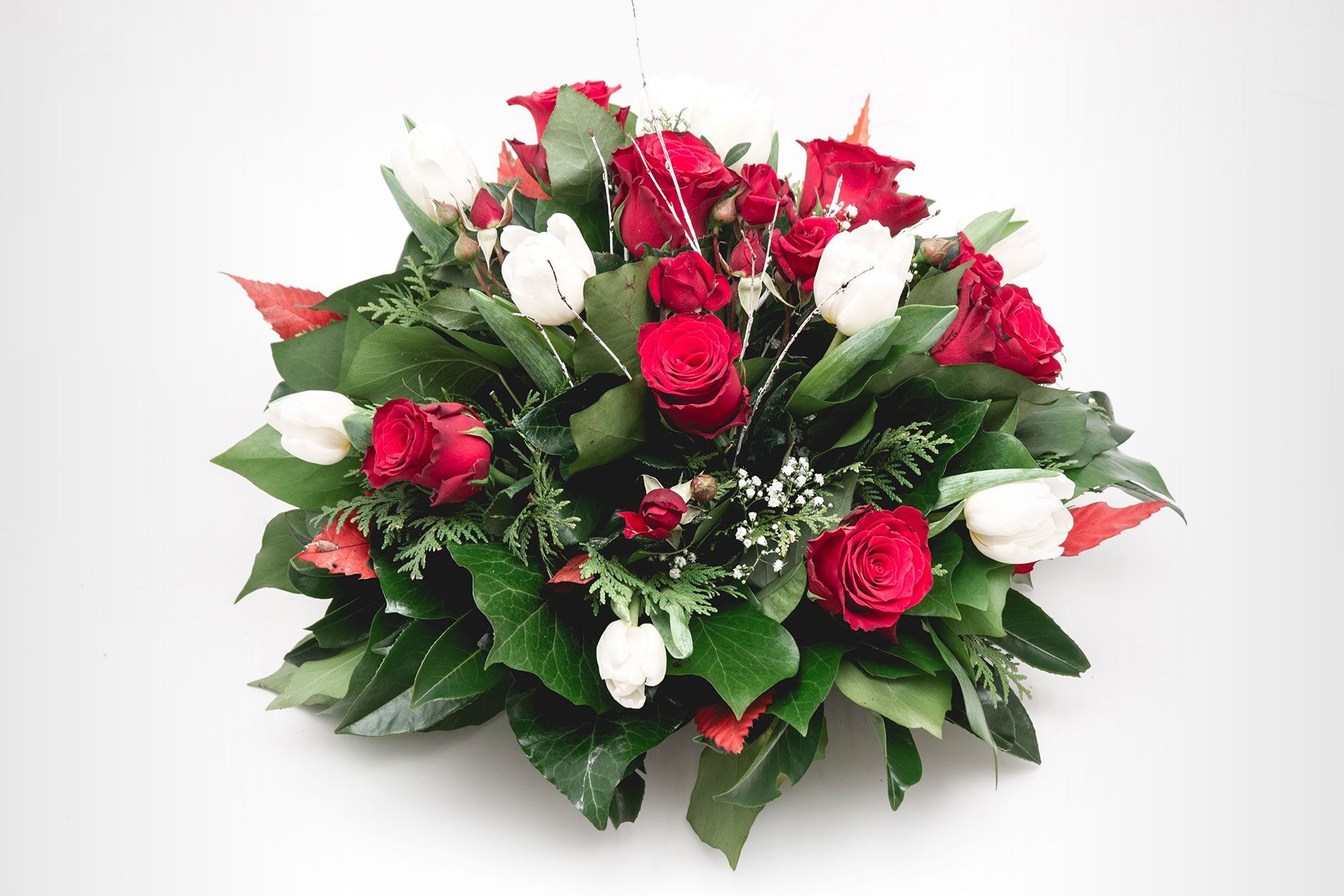 A bouquet of red roses and white tulips on a white background