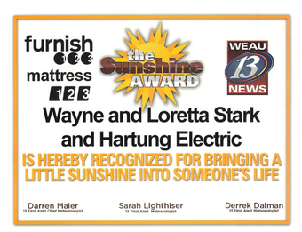 The Sunshine Award provided by WEAU 13 News for Wayne and Loretta Stark at Hartung Electric
