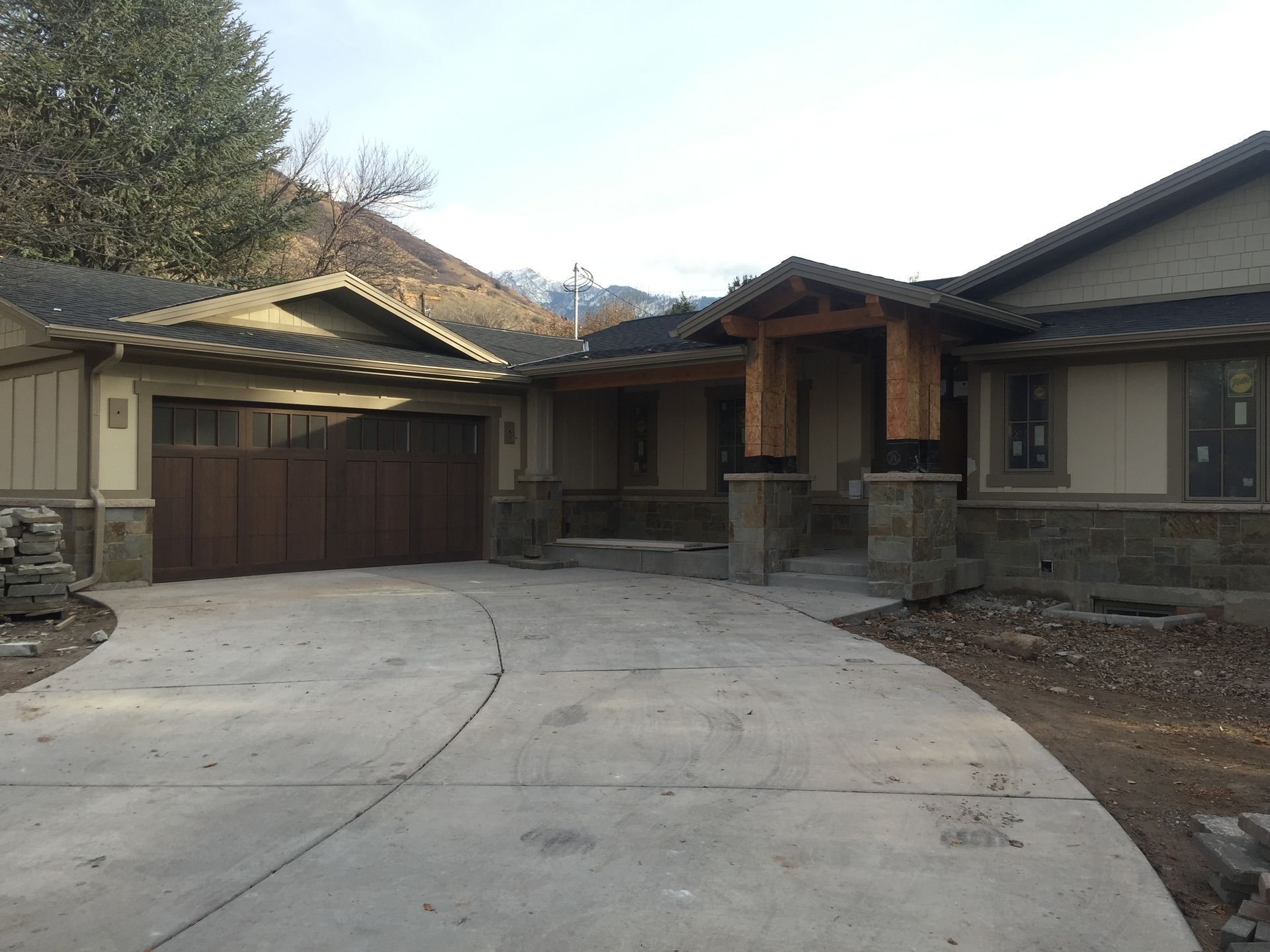 Front view of a suburban house with a two-car garage and curved concrete driveway