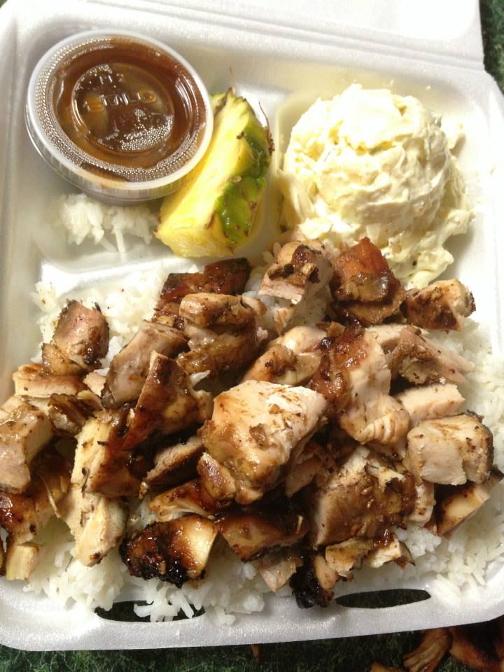 Takeout meal with grilled chicken, mashed potatoes, avocado, and sauce in a foam container