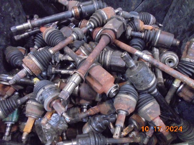 Pile of rusted automotive axle shafts in a container