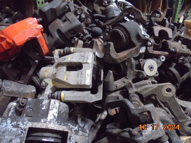 Pile of used car brake calipers in various sizes 