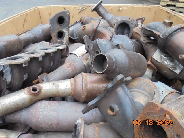 Pile of rusty catalytic converters in a cardboard box