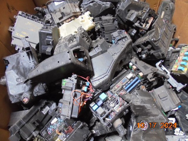 Pile of black automotive fuse boxes