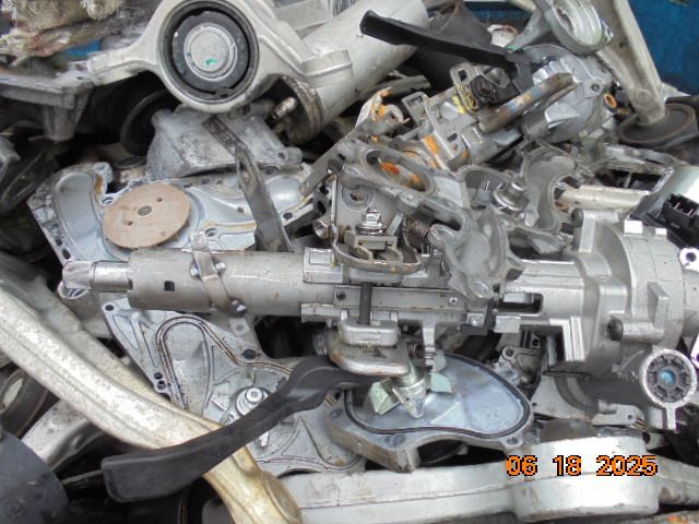 Pile of disassembled car steering columns and parts