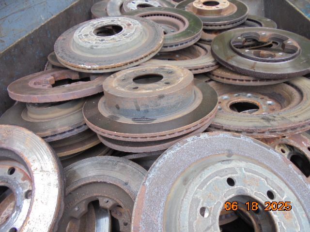 Pile of used, rusty car brake rotors