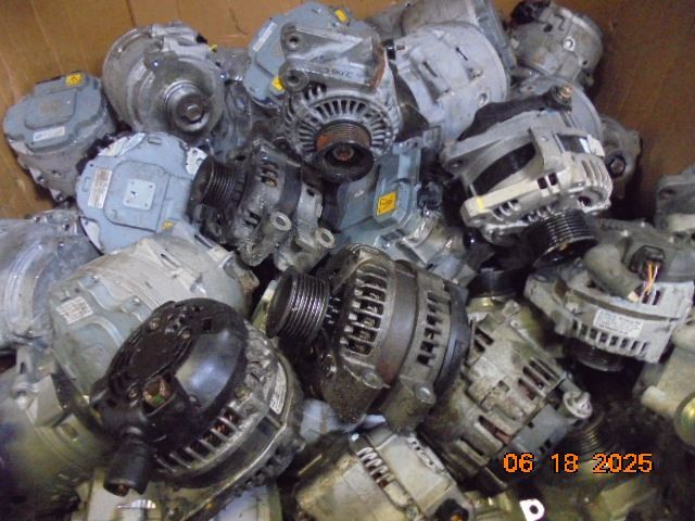 Pile of used vehicle alternators in a box