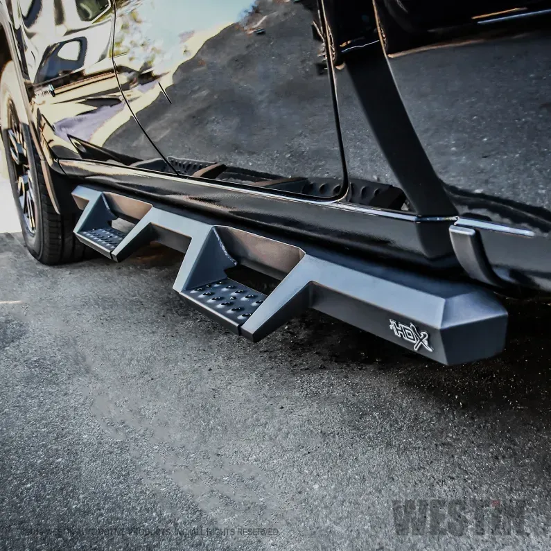 Black truck side step running board with textured step pad and “Westin” branding