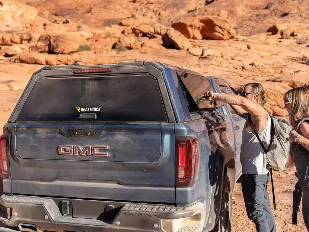 Rear view of a gray SUV with black trim and tinted windows, shown at an angle