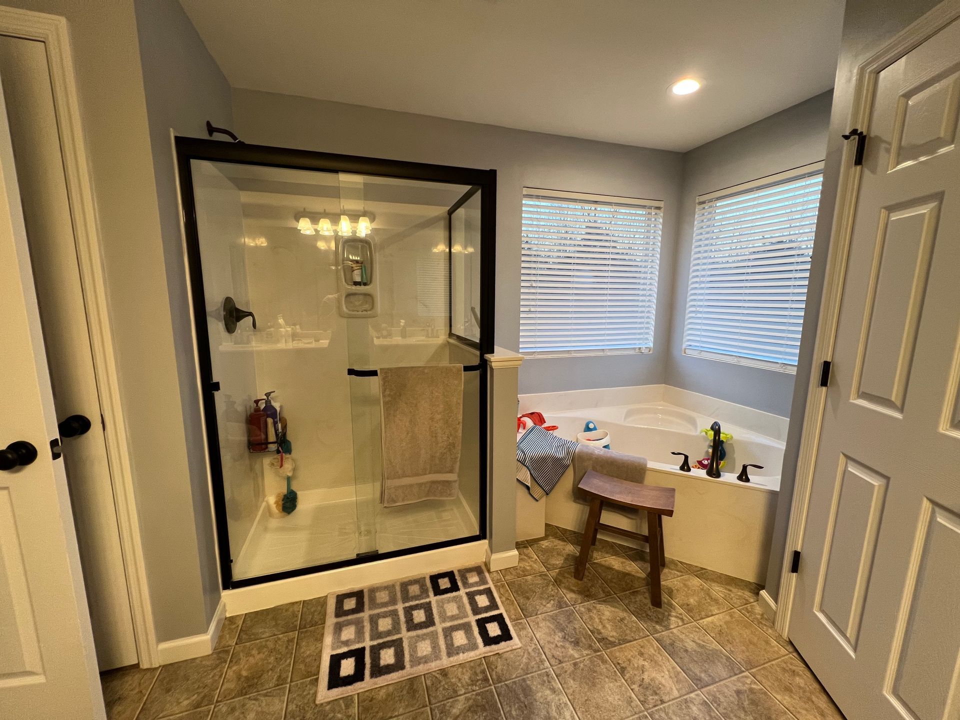 A bathroom with a tub, shower, and window.