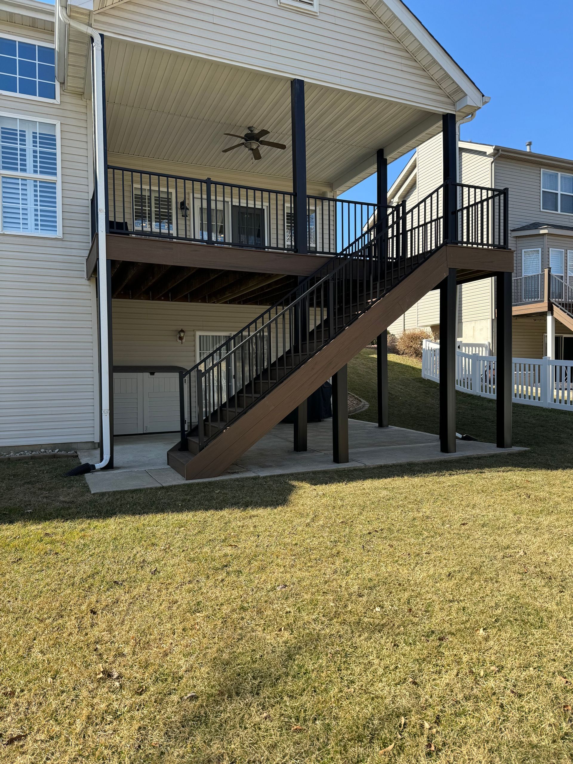 A house with a deck and stairs leading up to it