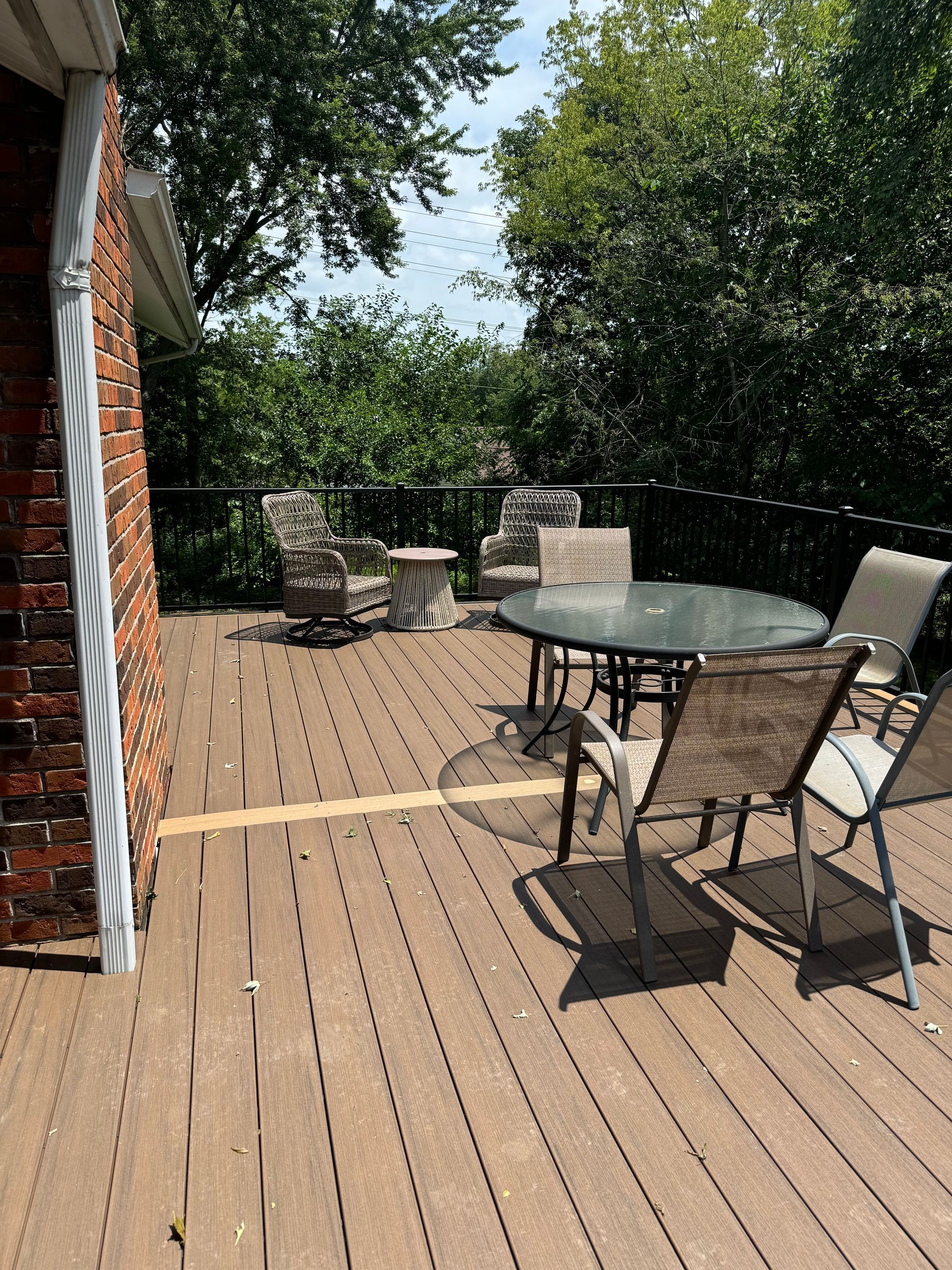 A wooden deck with a table and chairs on it