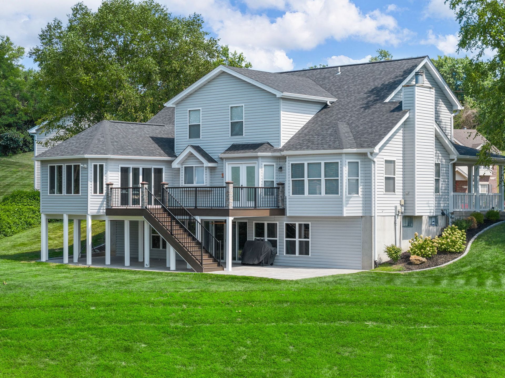 A large white house with a large lawn in front of it.