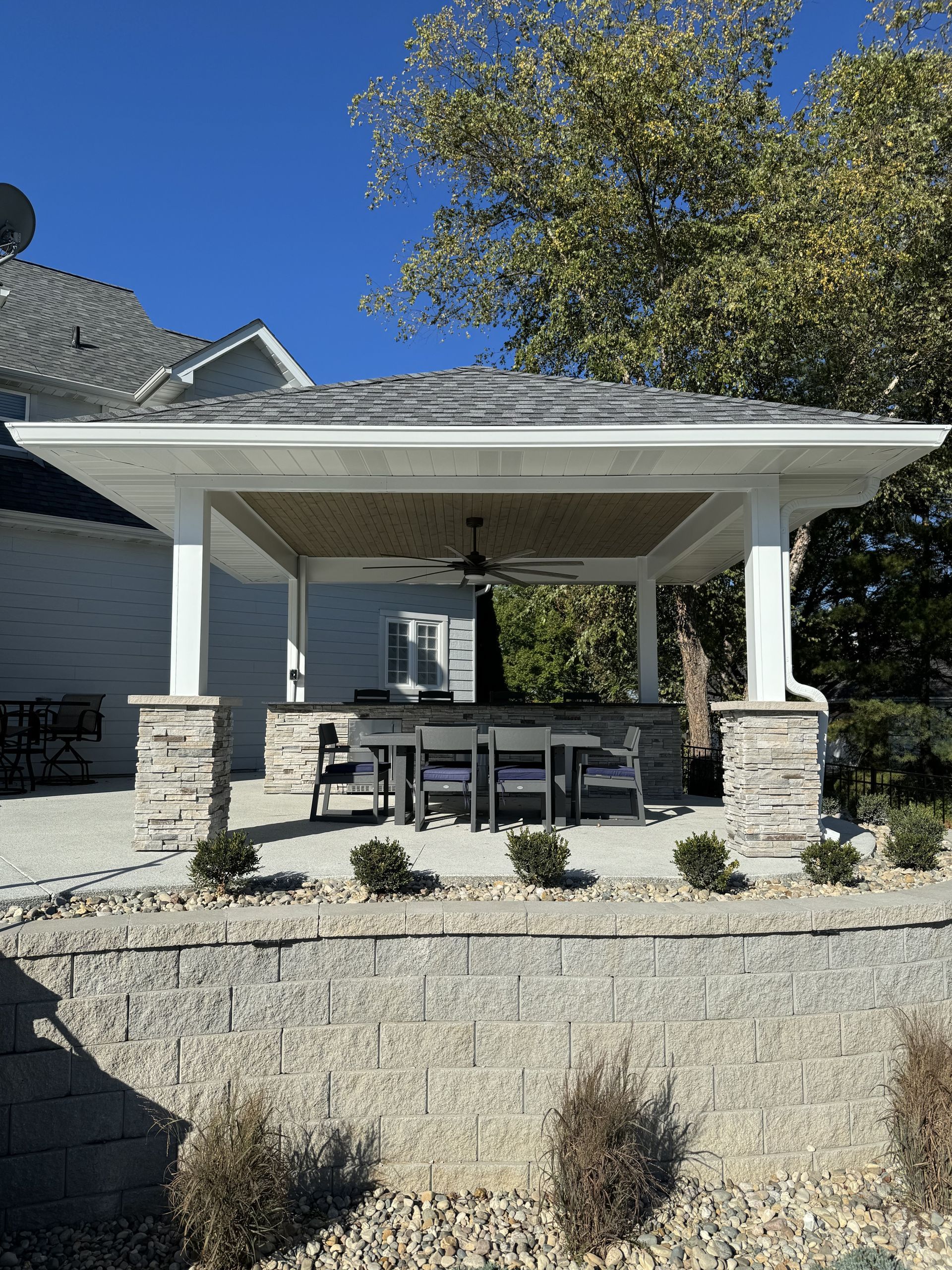 There is a pavilion with a table and chairs underneath it.