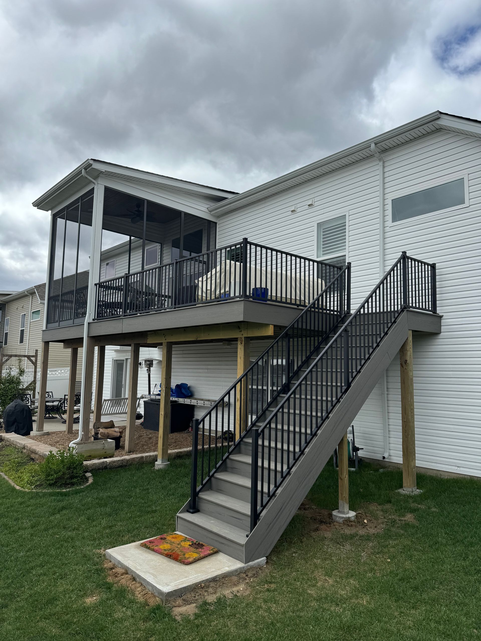 A house with a deck and stairs on the side of it.