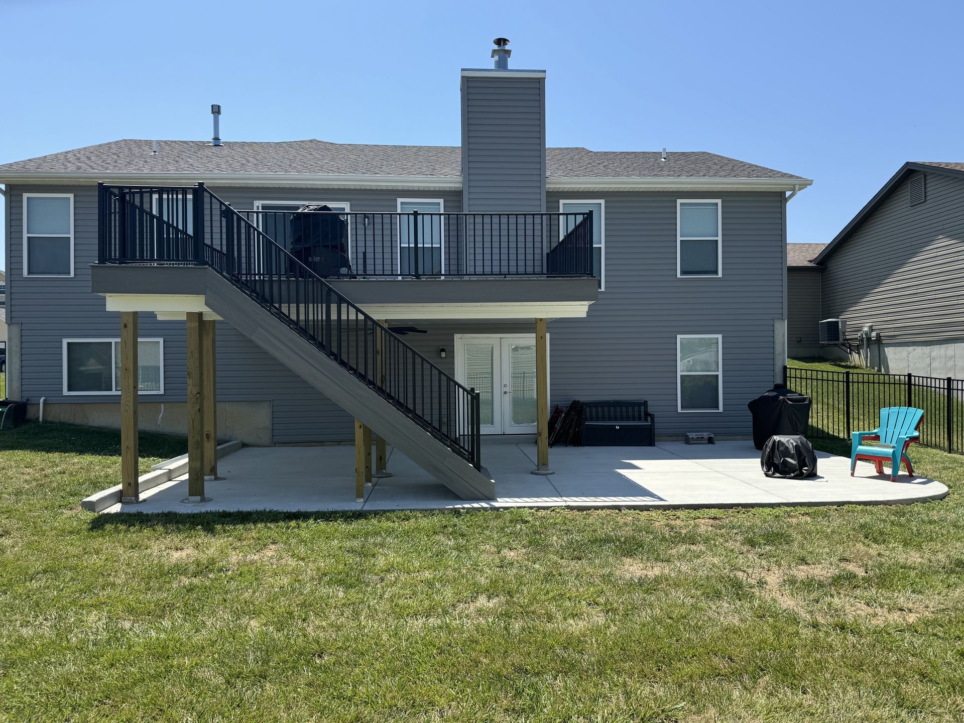 The back of a house with a deck and stairs.