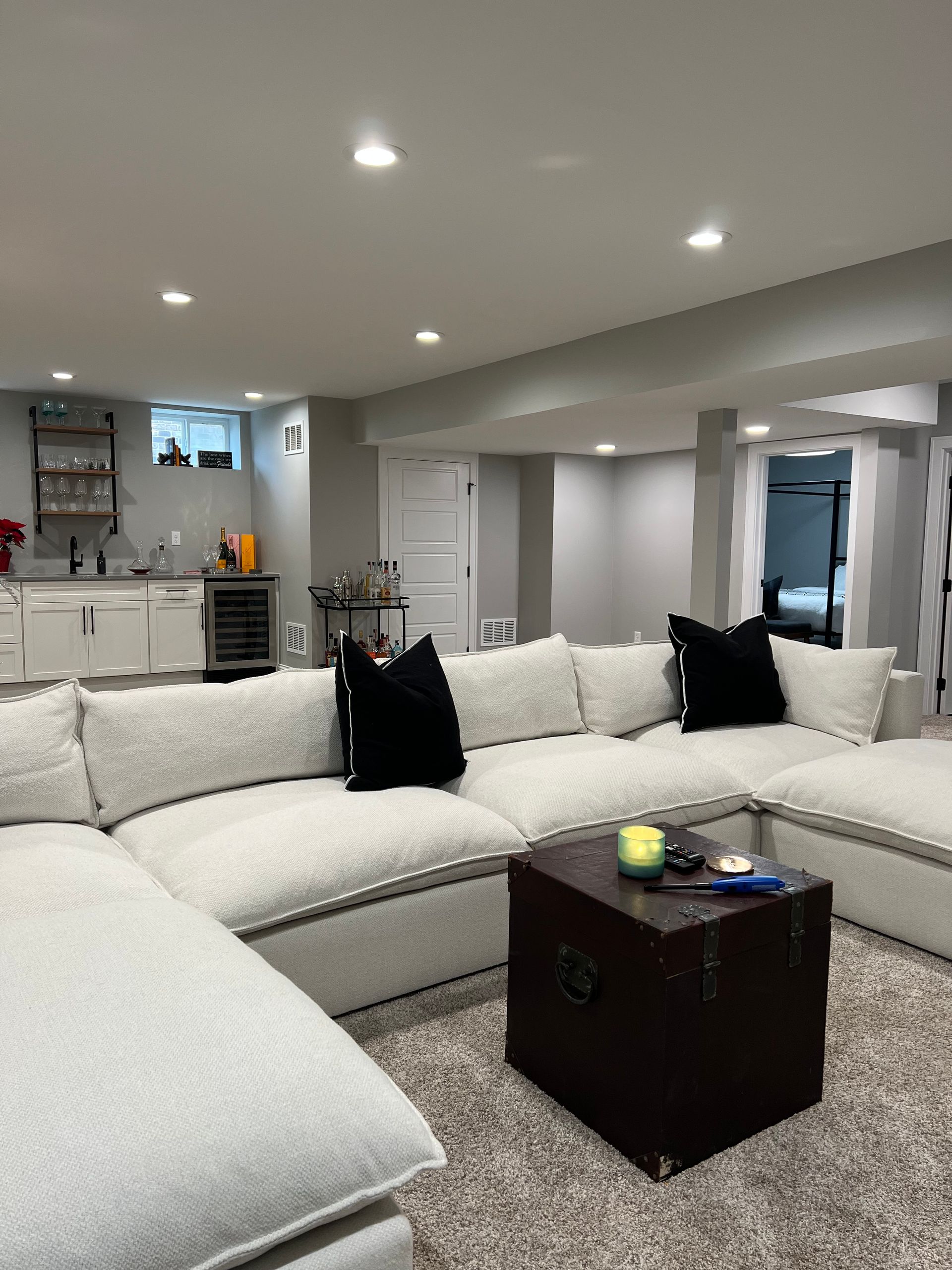 A living room with a large sectional couch and a coffee table