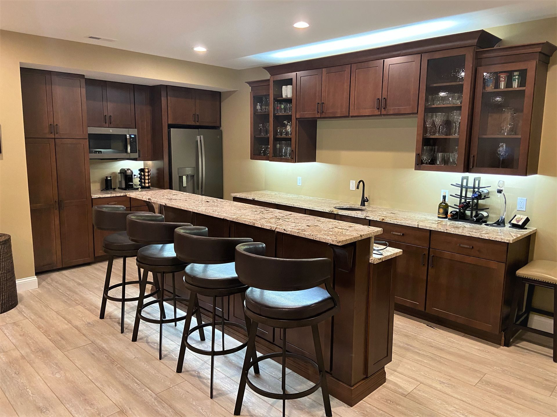 A kitchen with a bar and stools in it.