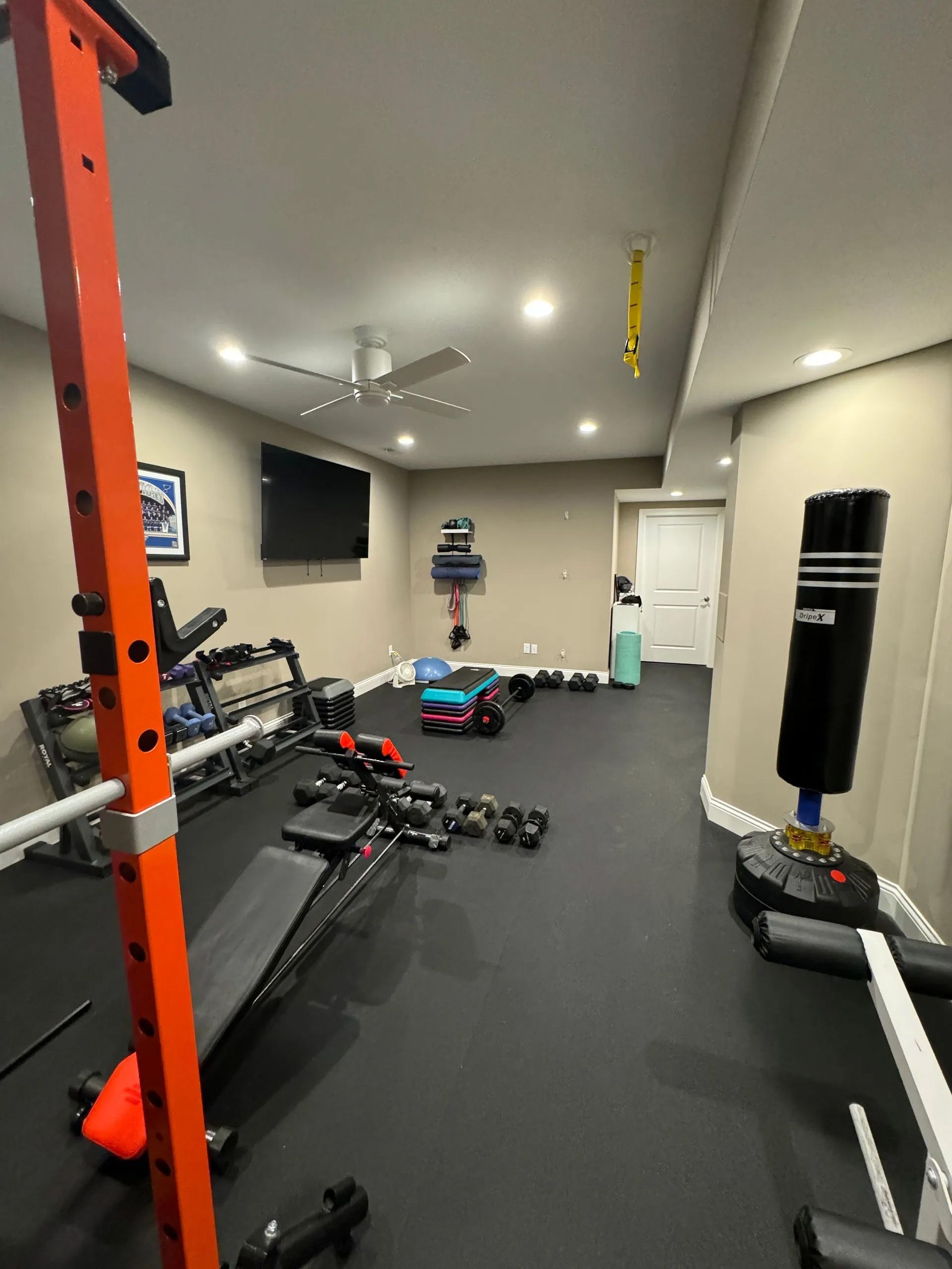 There is a boxing bag in the middle of the room