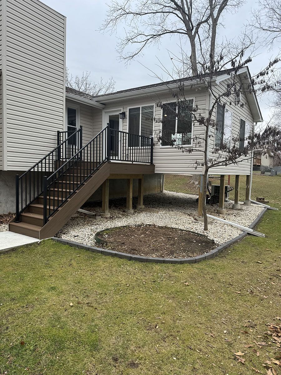 A house with a deck and stairs in the backyard