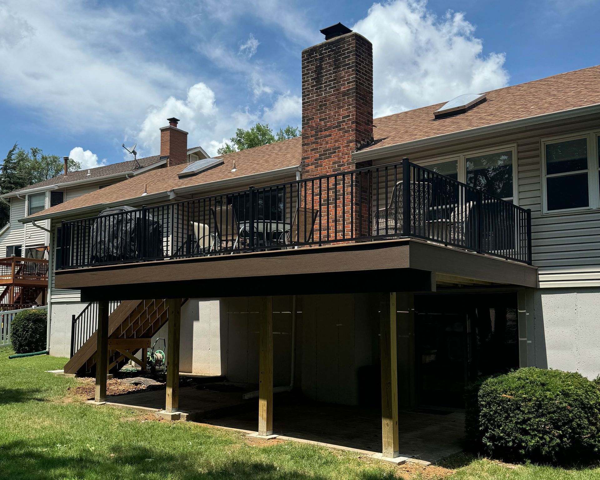 A house with a large new deck on the side of it