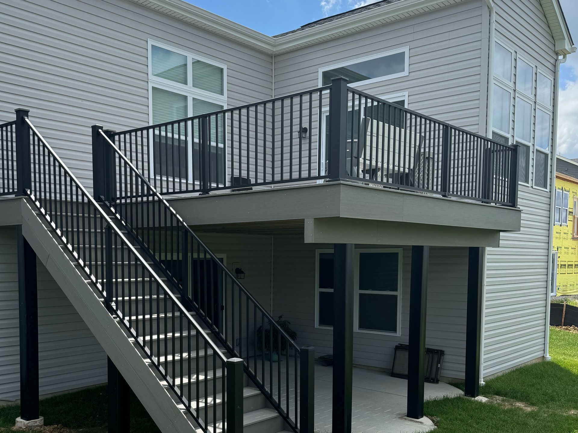 A house with a deck and stairs leading up to it