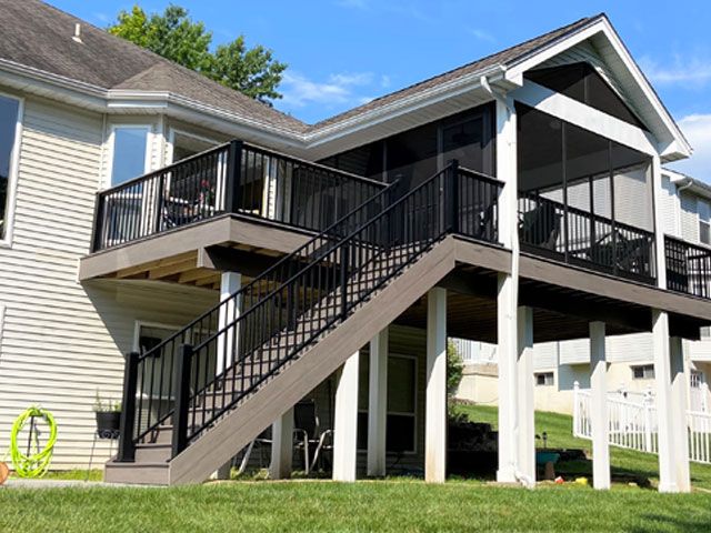 A house with a screened in porch and stairs leading up to it