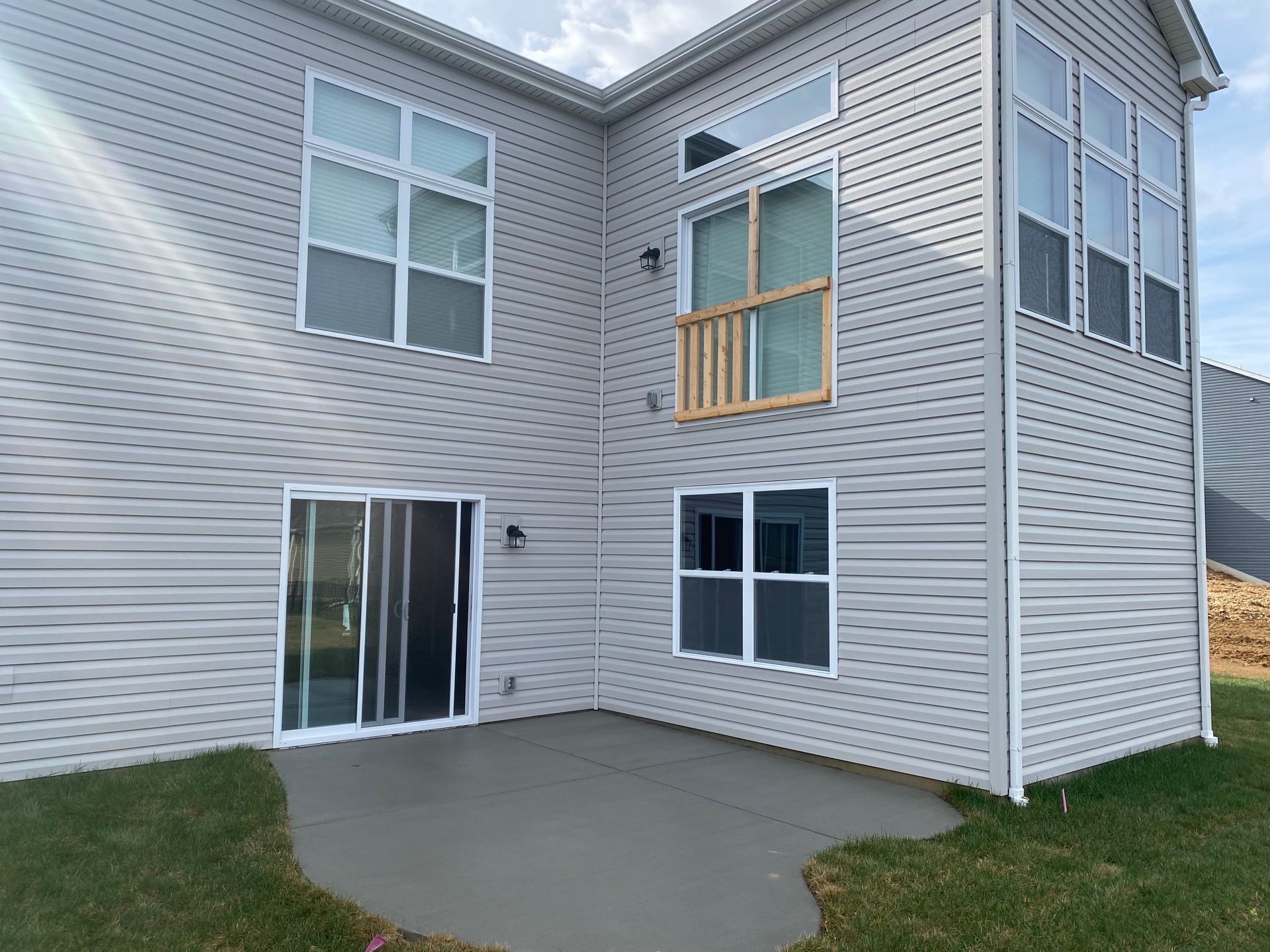 The back of a house with a patio and sliding glass doors