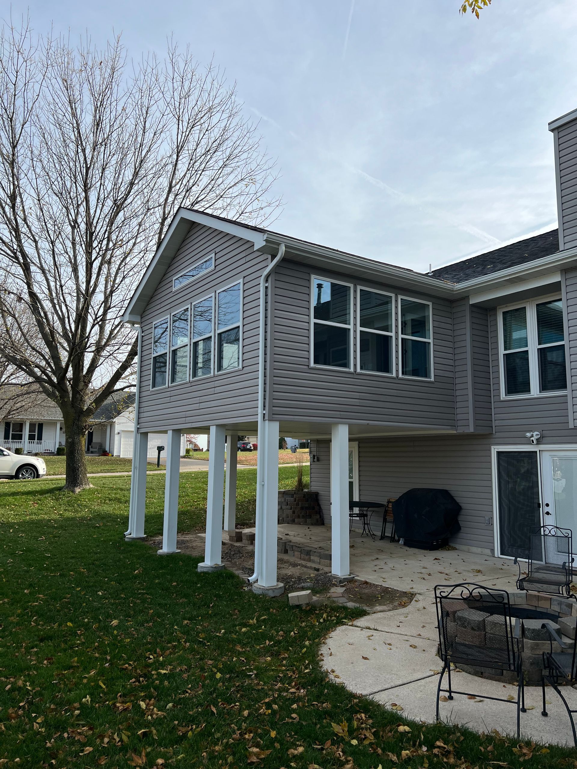 A large house with a lot of windows and a patio in front of it.