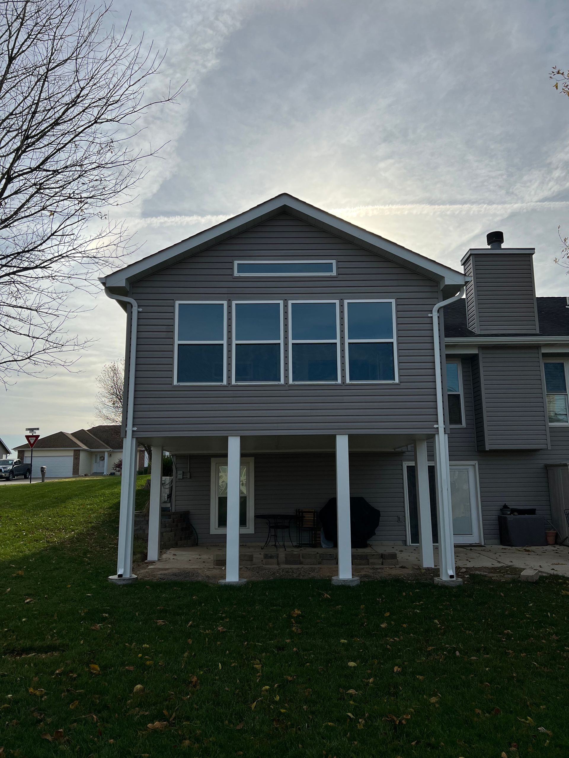The back of a house with a lot of windows