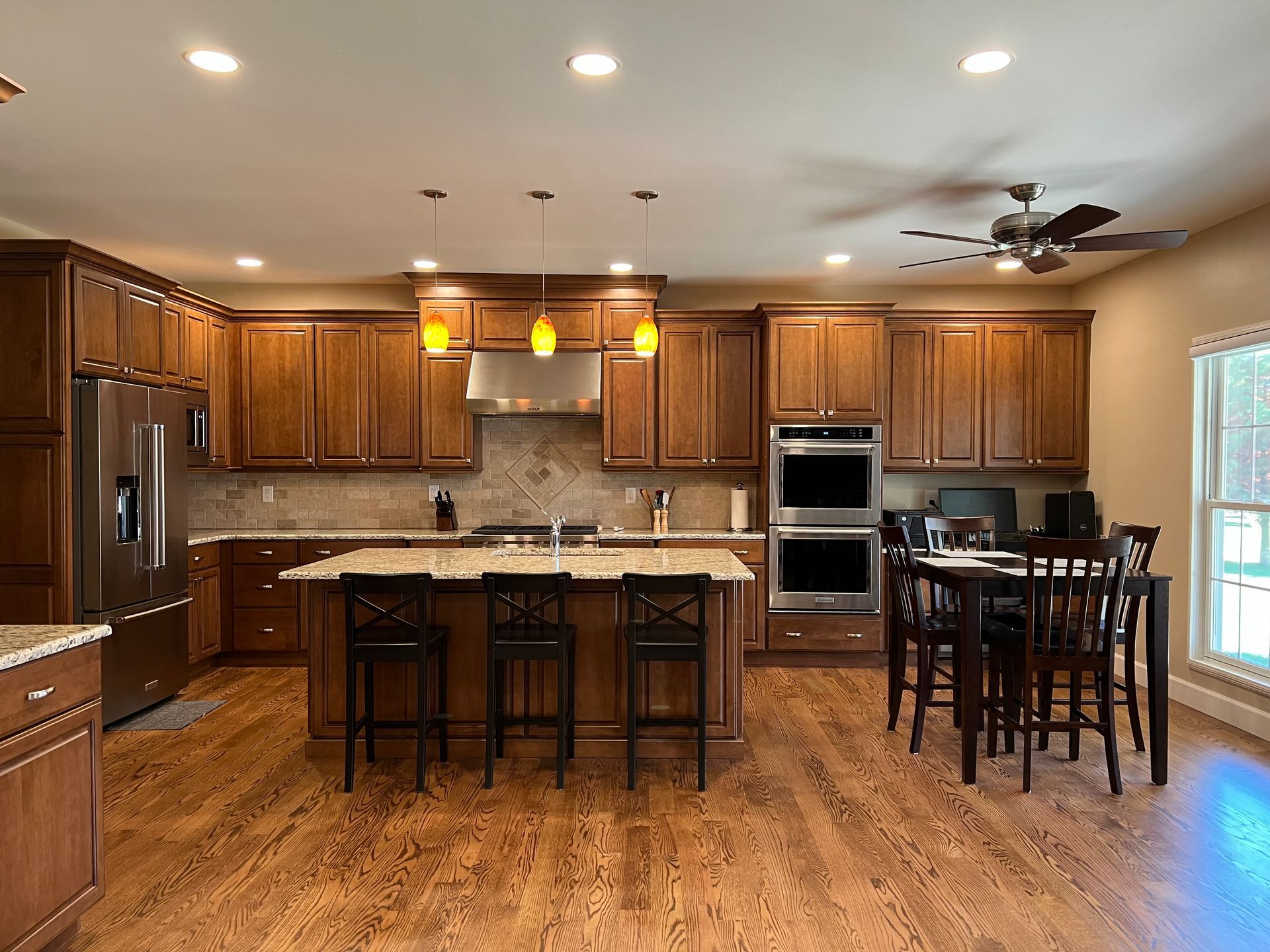 A kitchen with wooden cabinets and stainless steel appliances